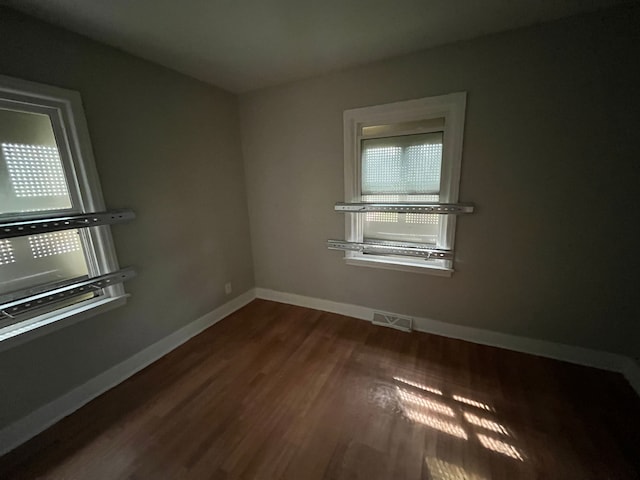 empty room with dark hardwood / wood-style floors