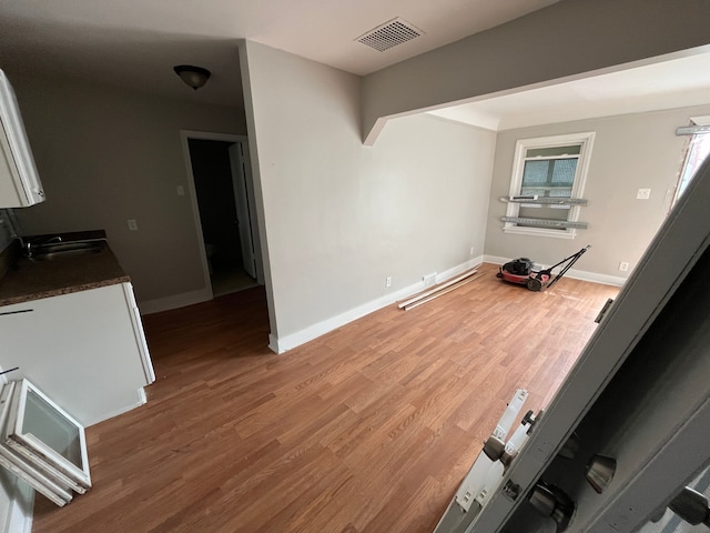 living room with hardwood / wood-style flooring and sink