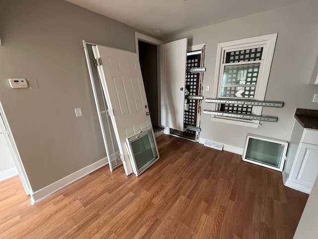 unfurnished living room featuring wood-type flooring