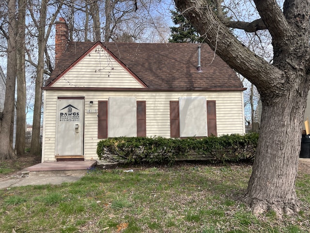 18109 Cornwall St, Detroit, MI 48224 - view of front of house featuring a chimney, a shingled roof, and a front lawn