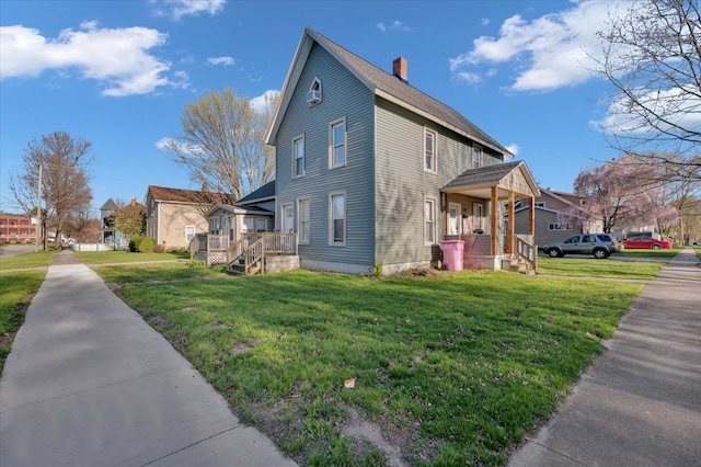 view of side of home featuring a lawn