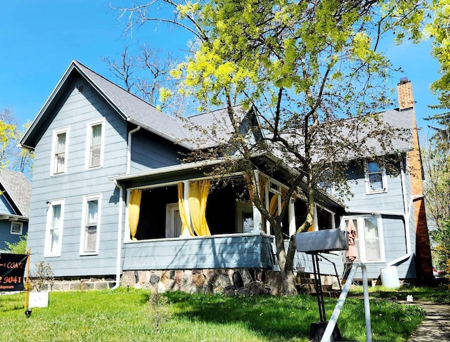 rear view of property with a yard