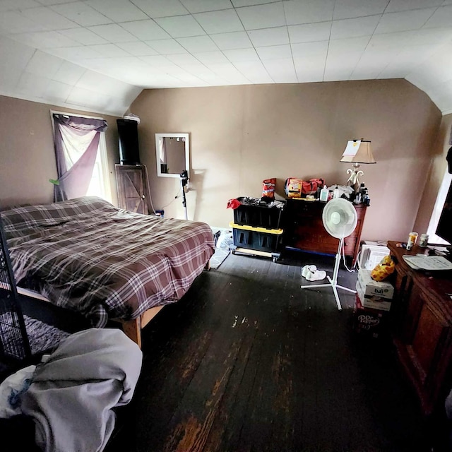 bedroom with wood-type flooring and lofted ceiling