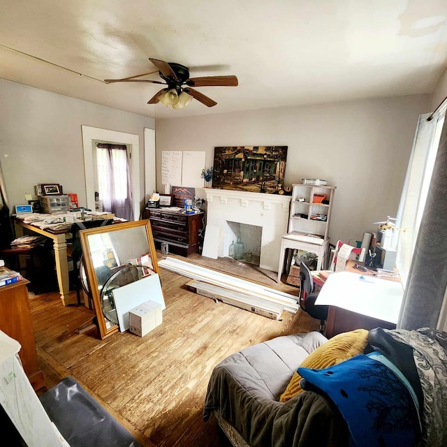 living room with hardwood / wood-style flooring and ceiling fan