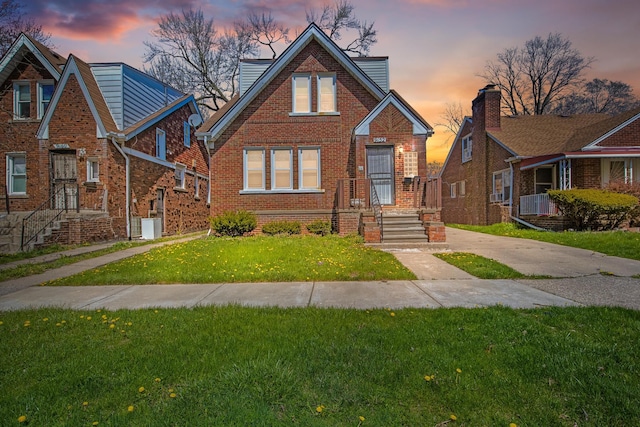 tudor-style house featuring a yard