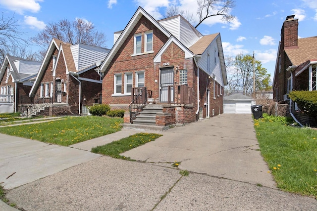 view of front of house with a front yard, an outdoor structure, and a garage