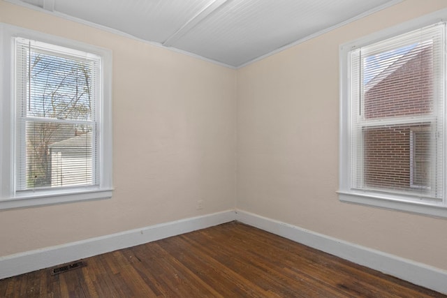 unfurnished room with dark wood-type flooring