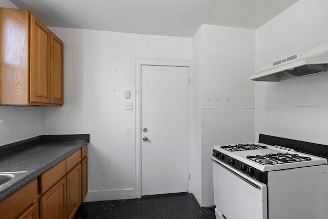 kitchen featuring exhaust hood and white range with gas cooktop