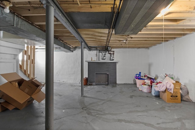 basement with a brick fireplace