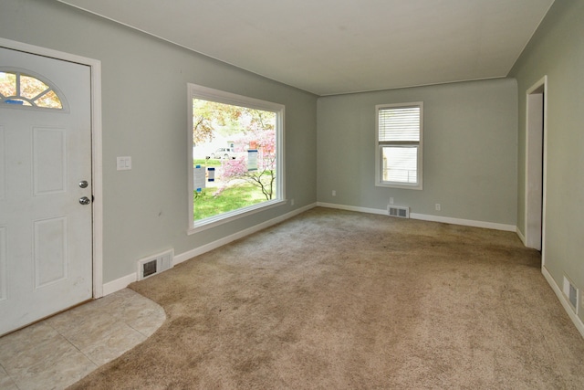 entrance foyer featuring light carpet