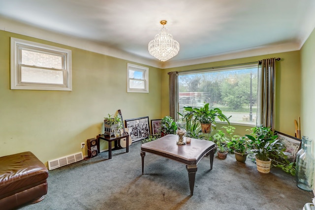 interior space with carpet, a notable chandelier, and a healthy amount of sunlight