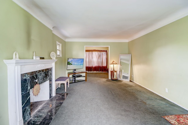 carpeted living room featuring a tiled fireplace