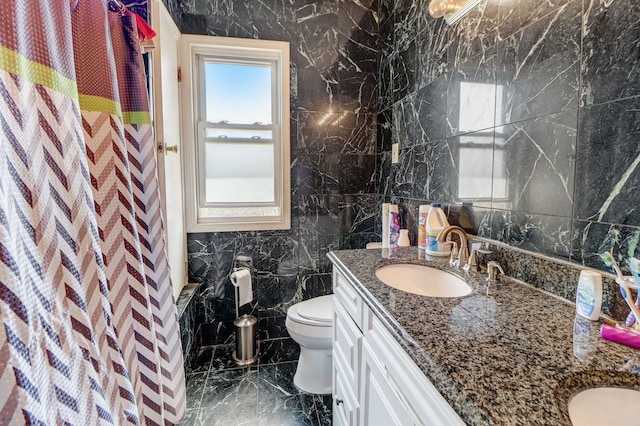 bathroom with a shower with curtain, vanity, toilet, and tile walls