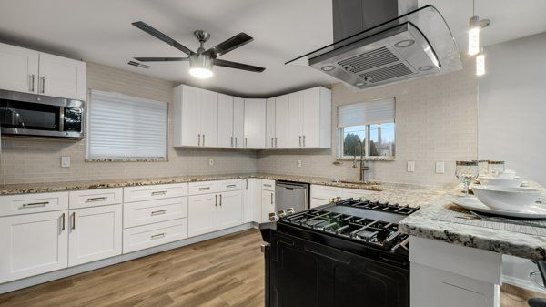 kitchen featuring white cabinetry, light hardwood / wood-style flooring, stainless steel appliances, and sink