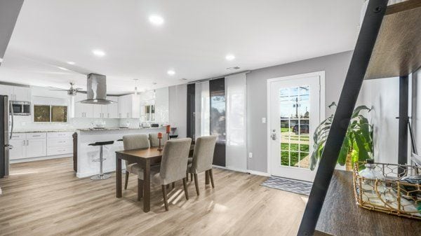 dining room featuring light wood-type flooring and ceiling fan