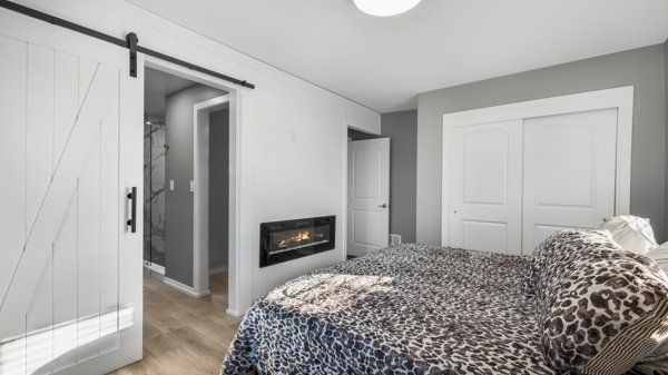 bedroom featuring a barn door, a closet, and light wood-type flooring