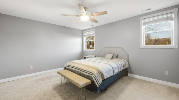 carpeted bedroom with ceiling fan