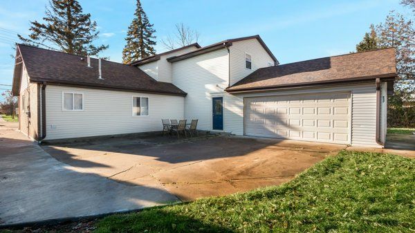 rear view of property featuring a garage