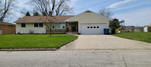 single story home with a front yard and a garage