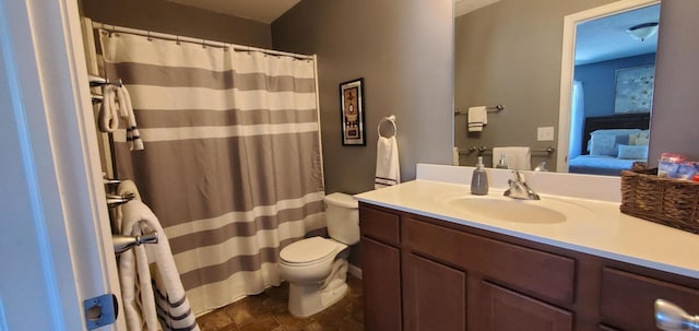 bathroom featuring a shower with curtain, vanity, and toilet