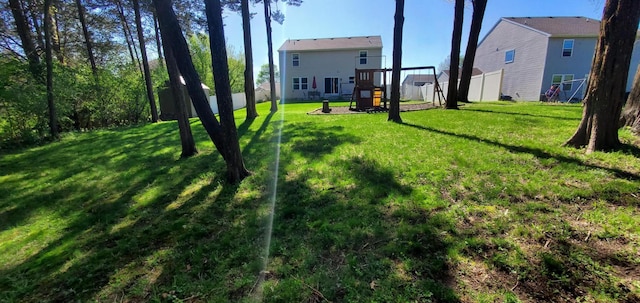 view of yard with a playground and a storage unit