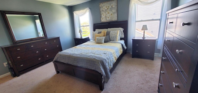 bedroom featuring light carpet