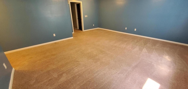 unfurnished room with light colored carpet