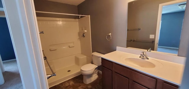 bathroom with walk in shower, vanity, and toilet