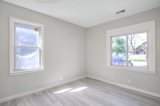 unfurnished room with light wood-type flooring