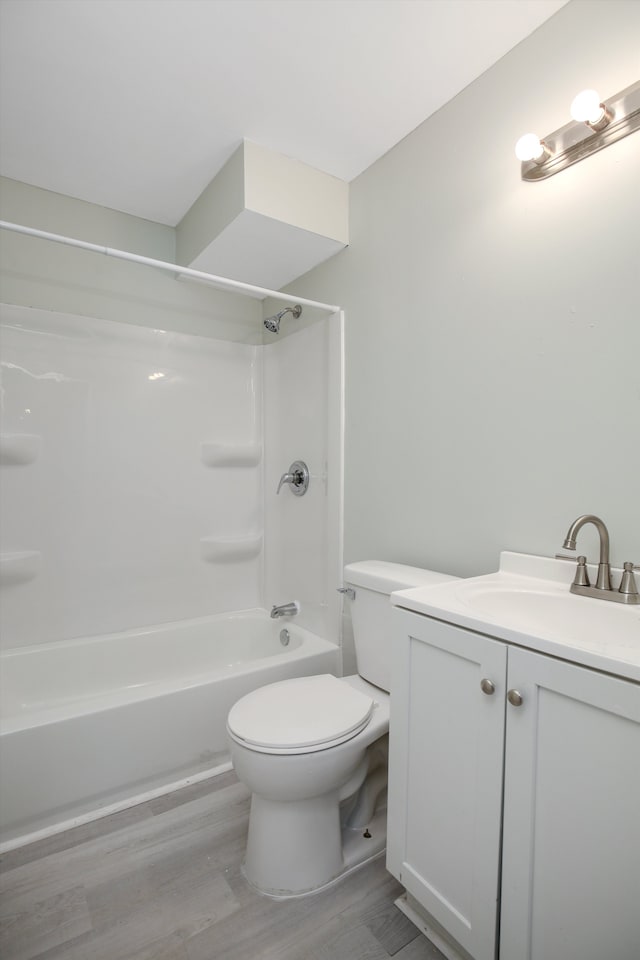 full bathroom featuring hardwood / wood-style flooring, vanity, toilet, and shower / bath combination