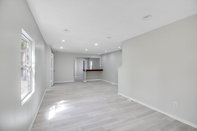 unfurnished living room with plenty of natural light and light hardwood / wood-style flooring