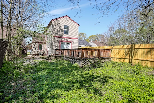 back of house with a wooden deck