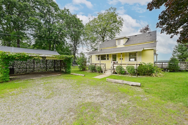 back of house featuring a lawn and a porch