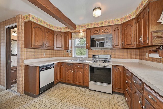 kitchen with decorative backsplash, beam ceiling, white appliances, and sink