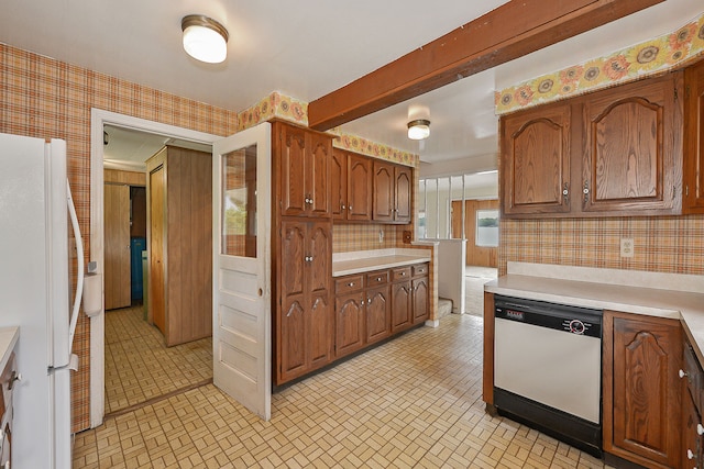 kitchen featuring decorative backsplash, light tile patterned flooring, and white appliances