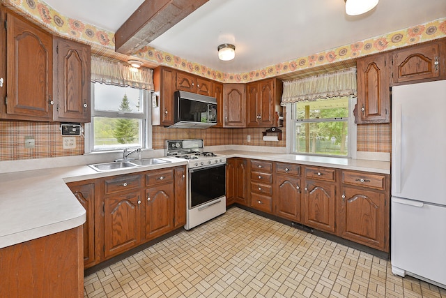 kitchen featuring beamed ceiling, decorative backsplash, white appliances, and sink