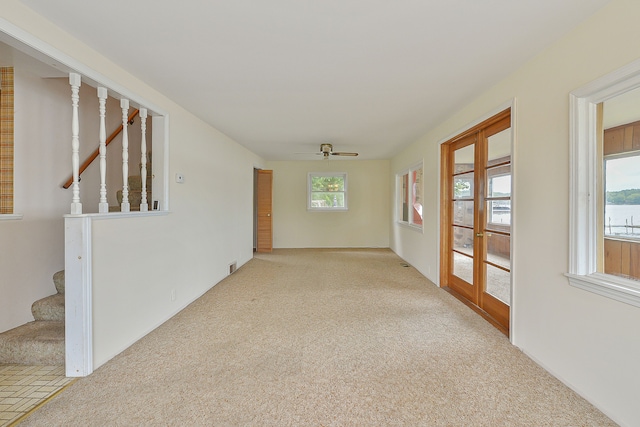 corridor with light carpet and a wealth of natural light