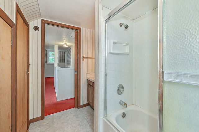 bathroom with shower / bath combination with glass door, vanity, and tile patterned flooring