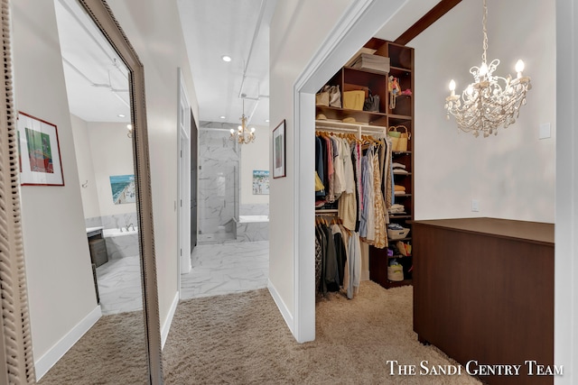 walk in closet with light carpet and a chandelier