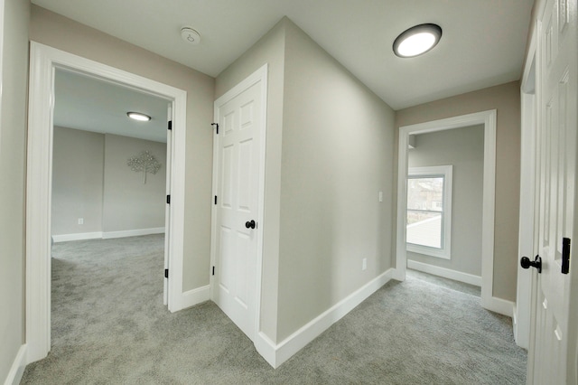 hall featuring light colored carpet