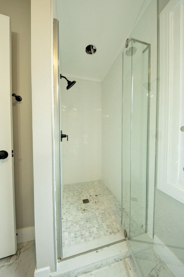 bathroom with a shower with shower door