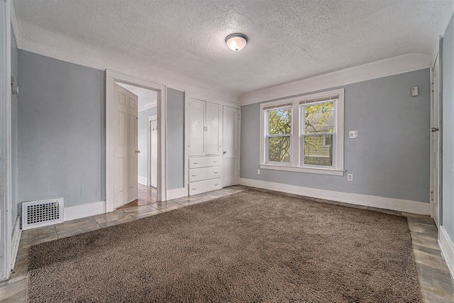 unfurnished bedroom featuring light colored carpet and a textured ceiling