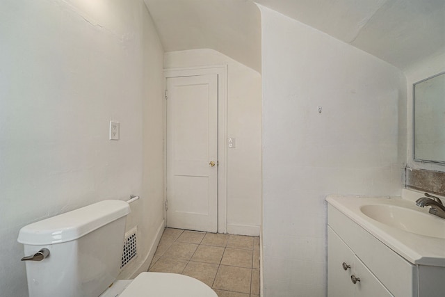 bathroom with tile patterned flooring, vanity, and toilet