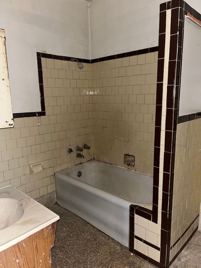 bathroom featuring a bathing tub, vanity, and tile walls