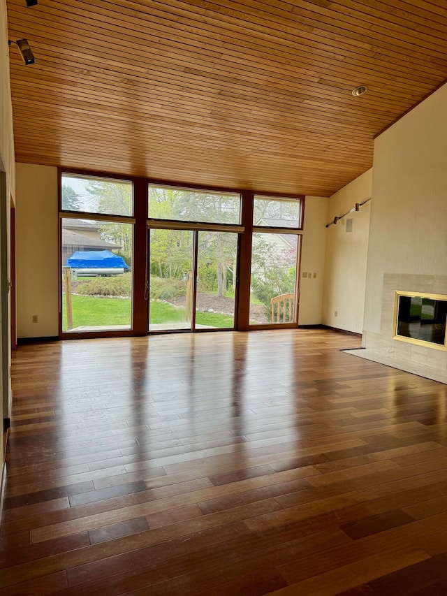 unfurnished living room featuring hardwood / wood-style floors and wood ceiling