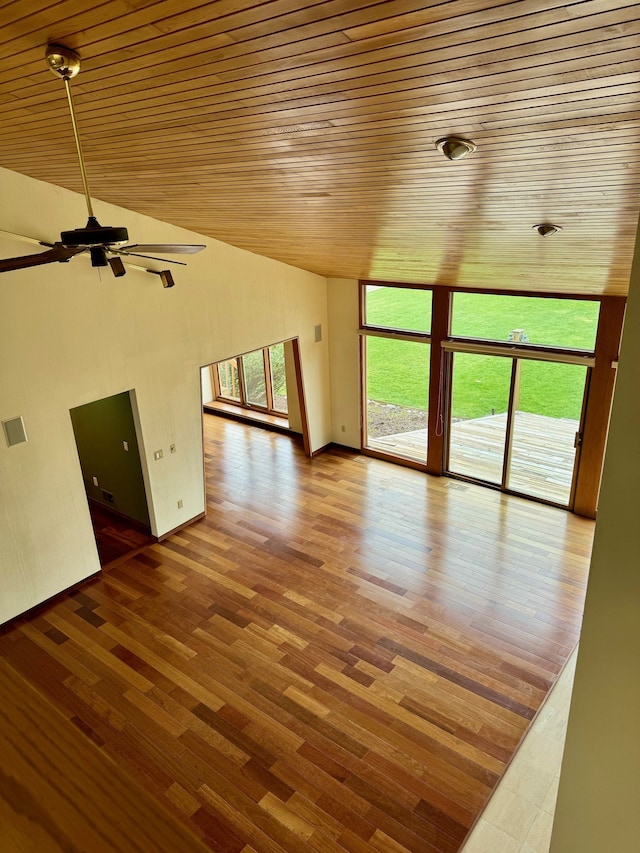 unfurnished living room with hardwood / wood-style floors, high vaulted ceiling, ceiling fan, and wood ceiling