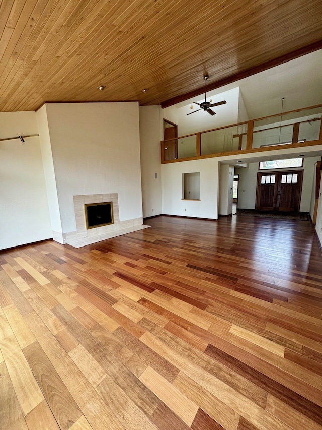 unfurnished living room featuring ceiling fan, vaulted ceiling, and light wood-type flooring