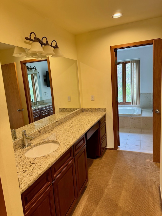 bathroom featuring vanity and tiled tub