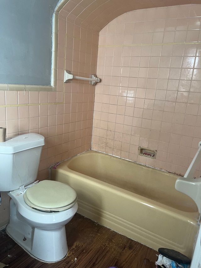 bathroom featuring toilet, tile walls, and hardwood / wood-style flooring