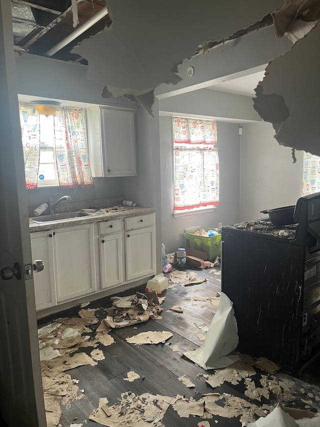 kitchen featuring sink and white cabinets